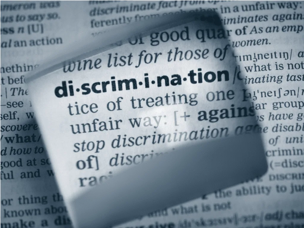Close-up of dictionary definition of “discrimination” to signify discussion of insurance redlining.